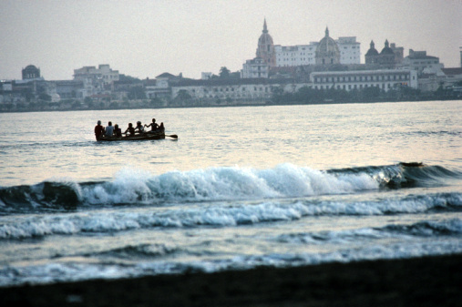 Fishermen paddle in the waters off Cartagena, Colombia