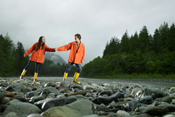 Couple walking along rocky riverbank