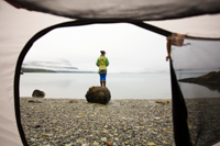 View through tent of woman on beach