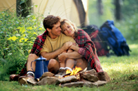 Couple sitting by campfire