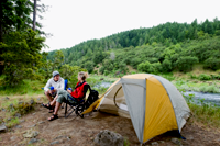 Couple relaxing at campsite