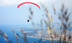 A paraglider flies over the beach of Vlore, Albania
