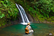 female hiker relaxing by a waterfall