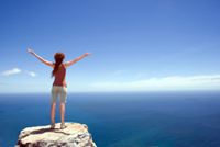 woman on rock seeing ocean
